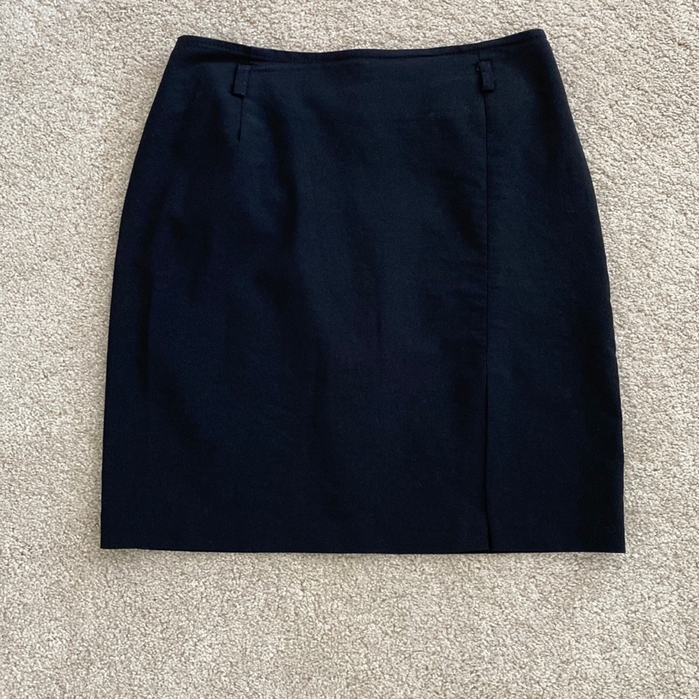 Black above knee skirt with front left leg slit and loops for skinny belt
